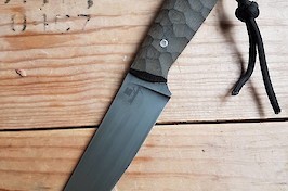 Slim and sharp utility knife in O1 carbon and linen micarta with black leather sheath.